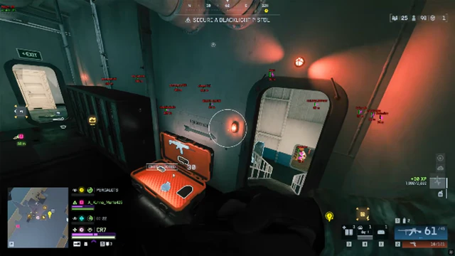 Battlefield 6 ship interior with a glowing orange loot crate and red-lit stairwell doors.