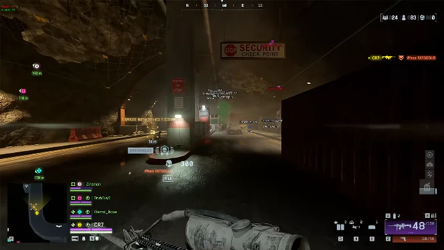 Battlefield 6 rocky tunnel security lane with a stop sign and pistol aimed toward the checkpoint.